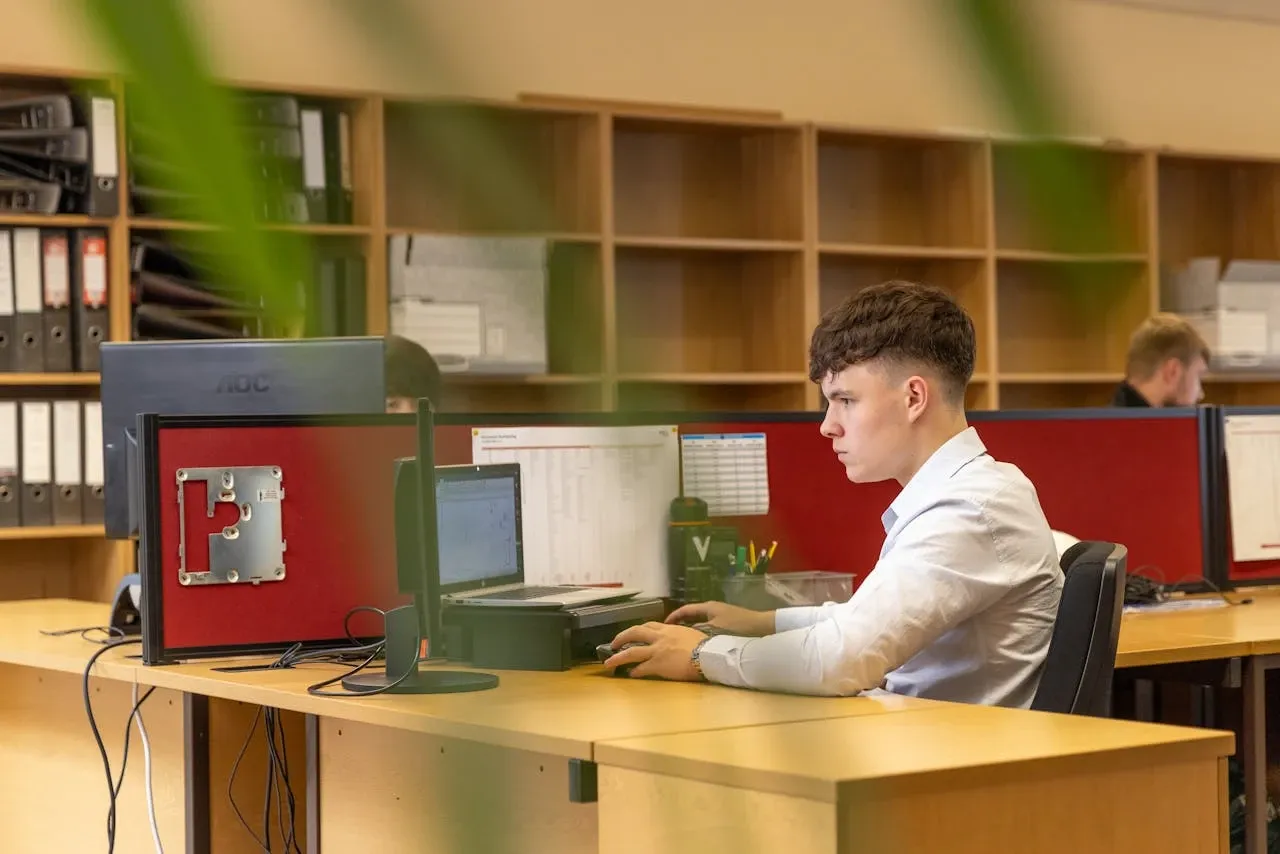 Jeune alternant au travail sur ordinateur